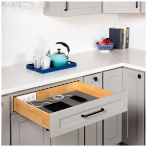 A kitchen drawer charging station charges a phone and tablet, keeping devices and cords off the counter and out of sight.