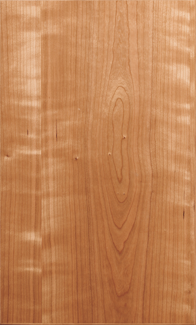 A close-up of a natural wooden surface with visible grain patterns and knots in a warm brown color.