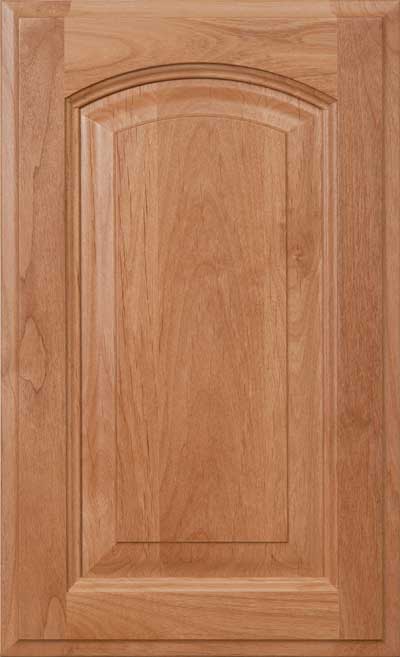 Wooden cabinet door with a raised center panel and arched top edge, finished in a light natural wood stain.